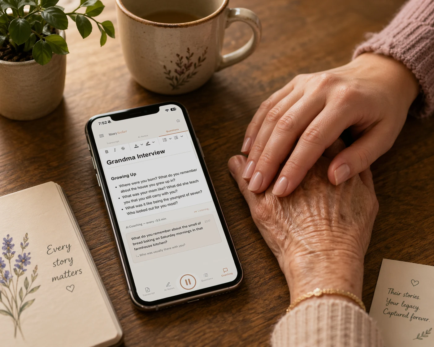 A phone on a kitchen table running StorySeeker, with a younger hand resting on an older hand nearby.